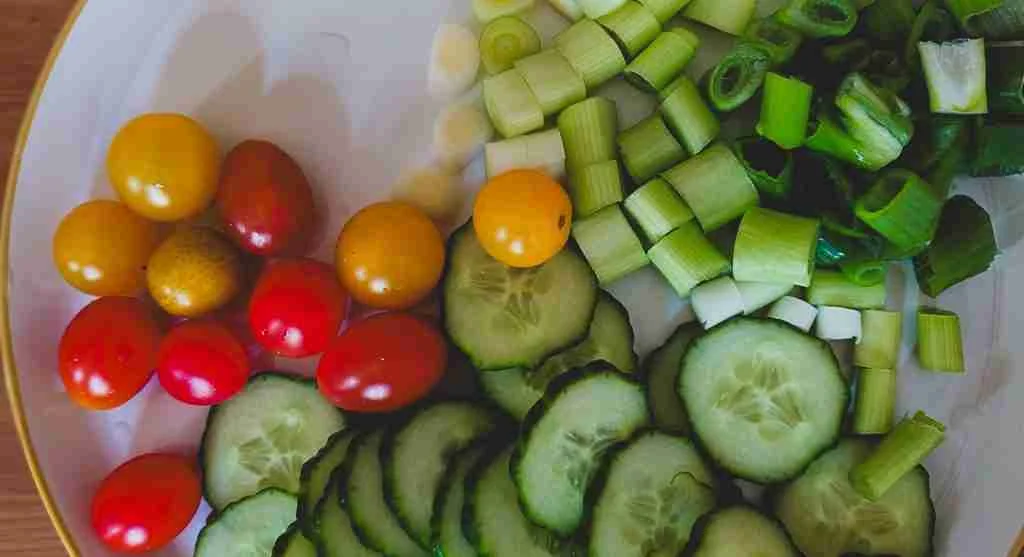 Grain bowl showing chopped cucumbers and cooked zucchini for freshness and texture comparison