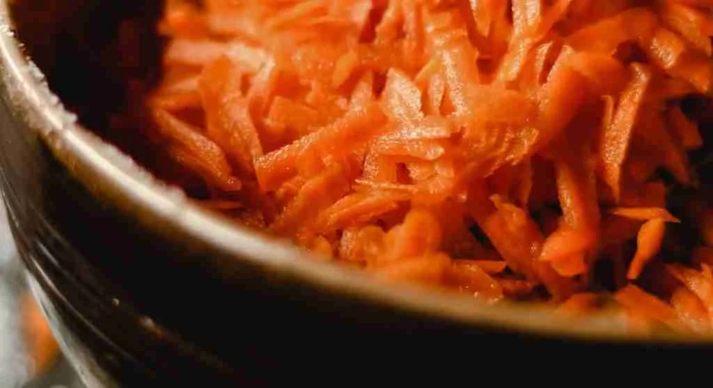 Shredded carrots and sliced carrots shown side by side for texture comparison